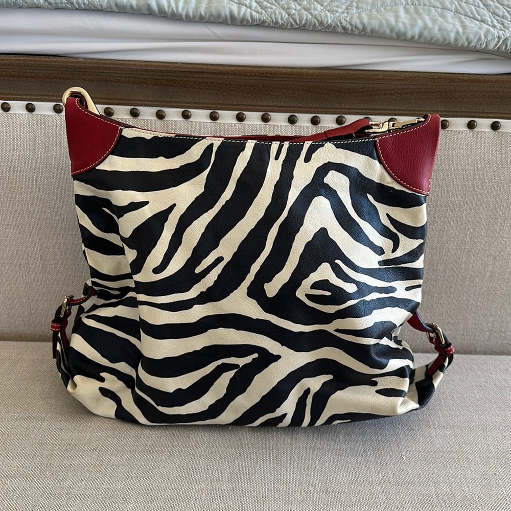 Dooney & Burke shoulder bag. Zebra with red accents. 12x16 with shoulder strap.